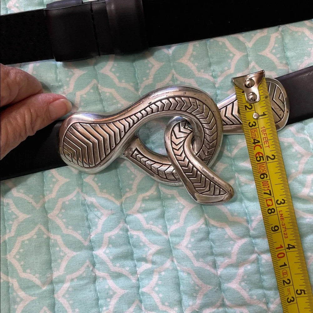Black leather statement belt with unique silver clasp